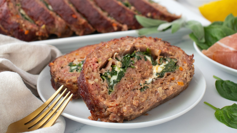 Saltimbocca-inspired stuffed meatloaf slices on plate