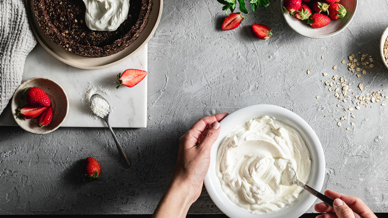 Hands mixing whipped cream