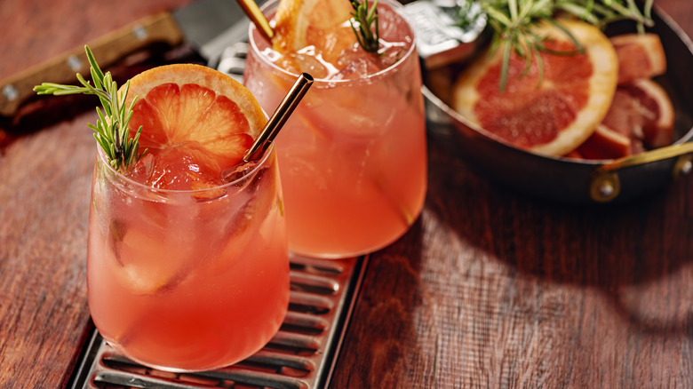 Palomas with grapefruit slices, rosemary, and metal straws