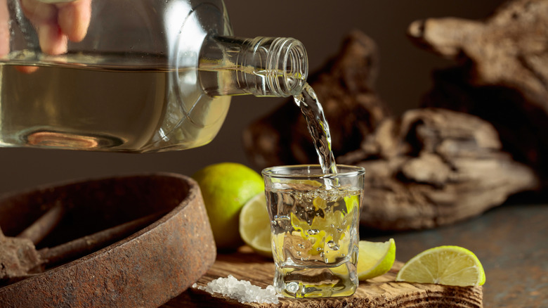 Tequila being poured into shot glass