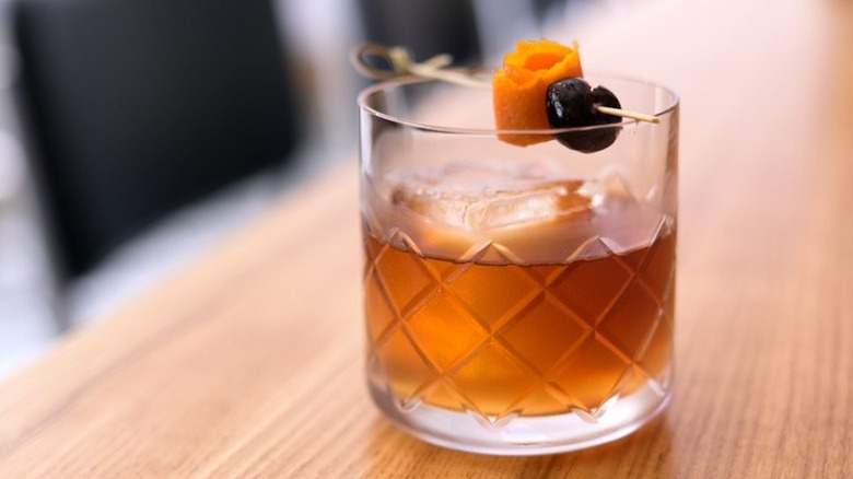 Fat-washed burbon cocktail with cherry and orange peel 