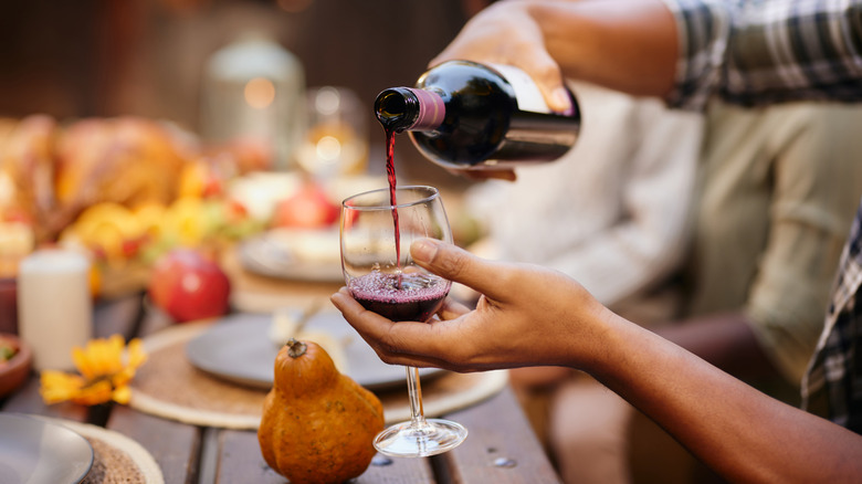 Pouring wine into a glass at table