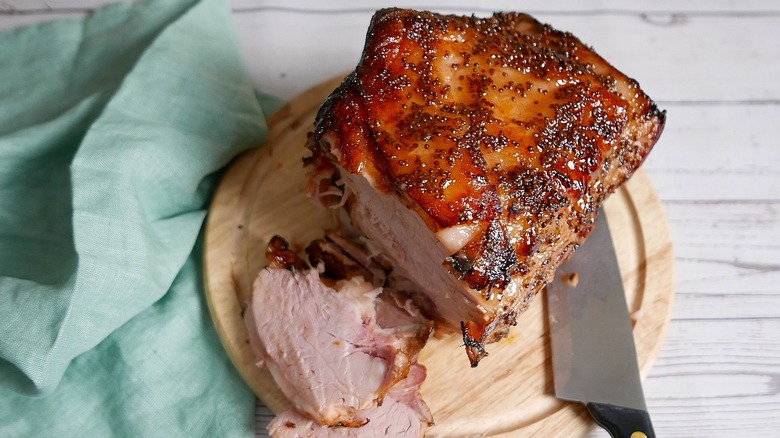 glazed ham joint on board