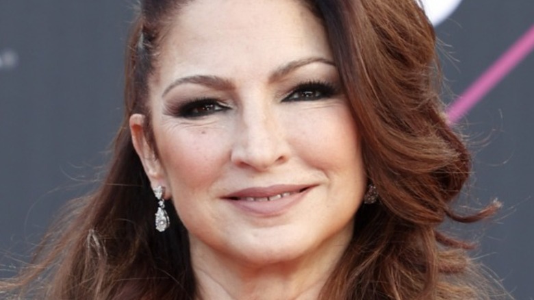 Close-up of Gloria Estefan wearing diamond earrings with hair in partial updo