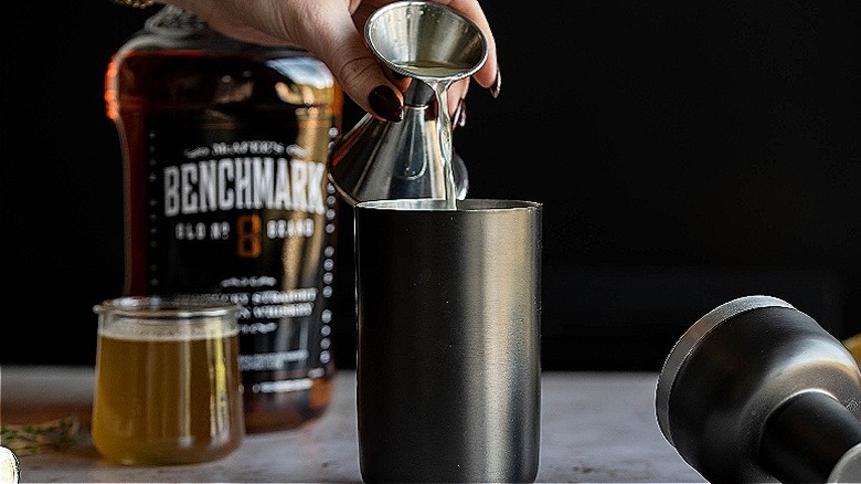 pouring lemon juice into shaker