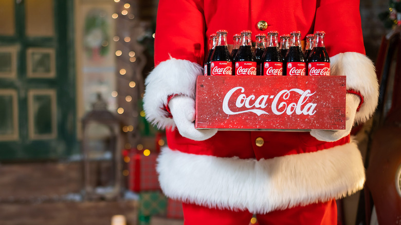Santa carrying coke bottles
