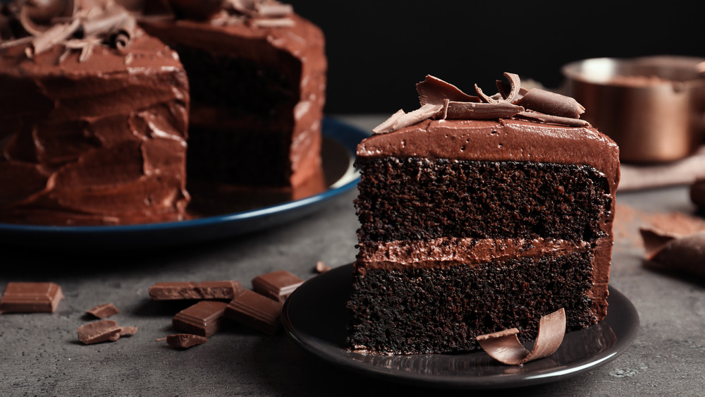 Slice of chocolate cake on a black plate