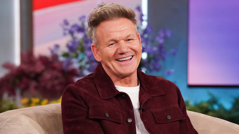 Gordon Ramsay sitting in chair and smiling