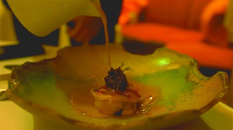 Sauce poured over a serving of the Breton lobster à la presse, the signature dish at Le Pressoir d'Argent.