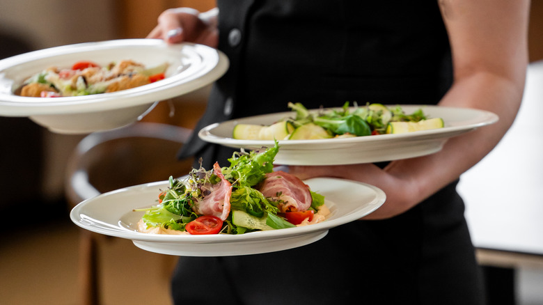 Server carrying dishes