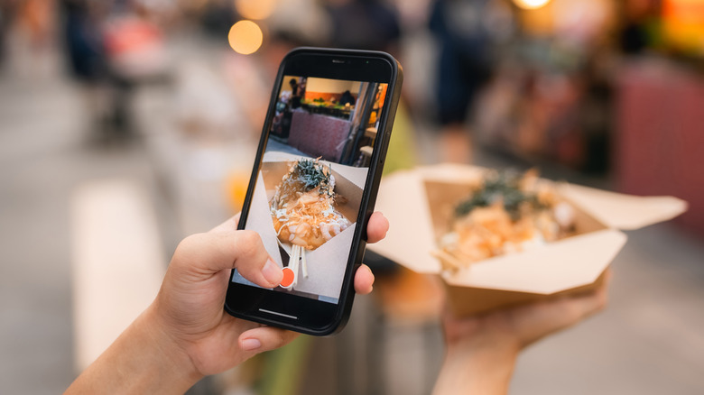 Person taking pic of food with cell phone