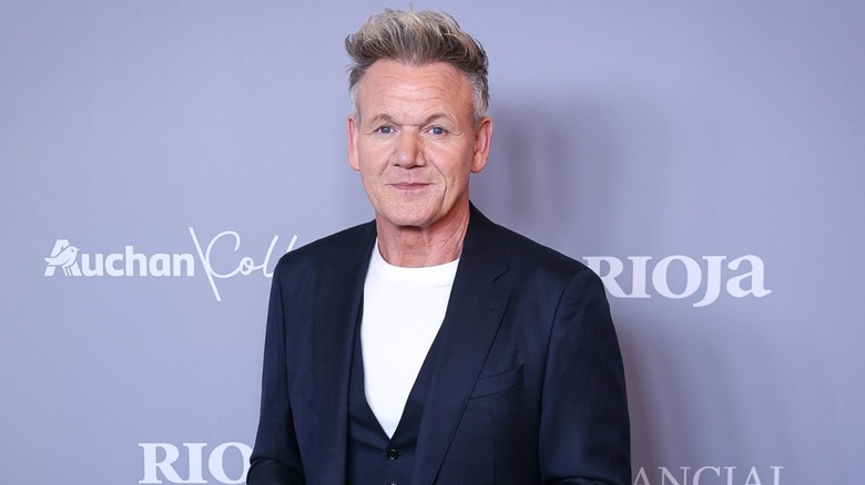 Gordon Ramsay at a red carpet event in a white tee and navy blazer