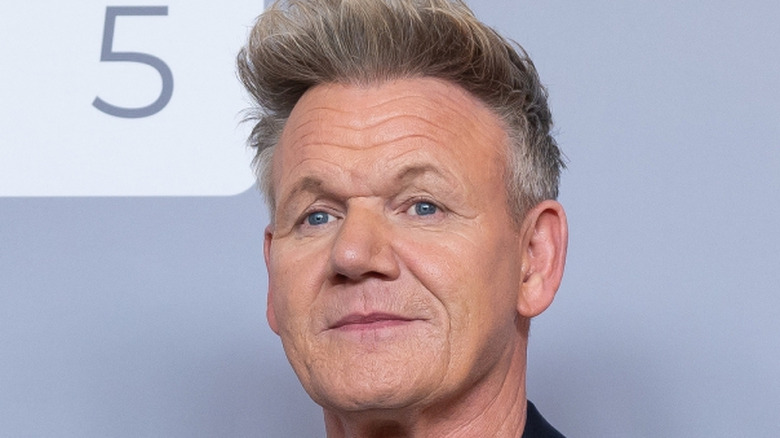 Gordon Ramsay in front of a blue-gray background.