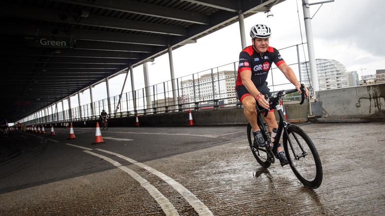 chef gordon ramsay riding bicycle on city street