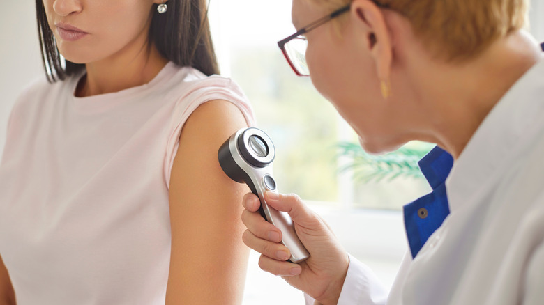 dermatologist examining a patient's skin