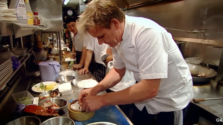 Gordon Ramsay makes dim sum in a restaurant kitchen with Chinese chefs looking on