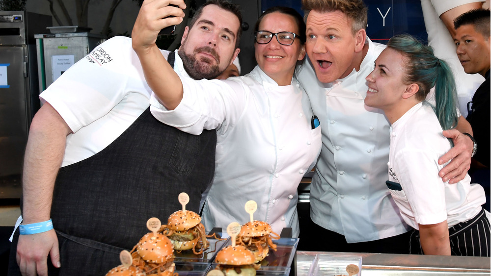 Gordon Ramsay and his chefs take selfie in front of hamburger display