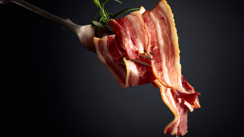 Strips of bacon on a fork