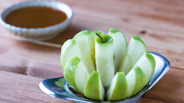 sliced green apple with caramel dipping sauce