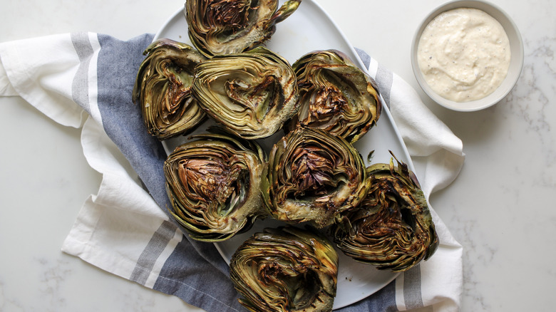 grilled artichokes on platter