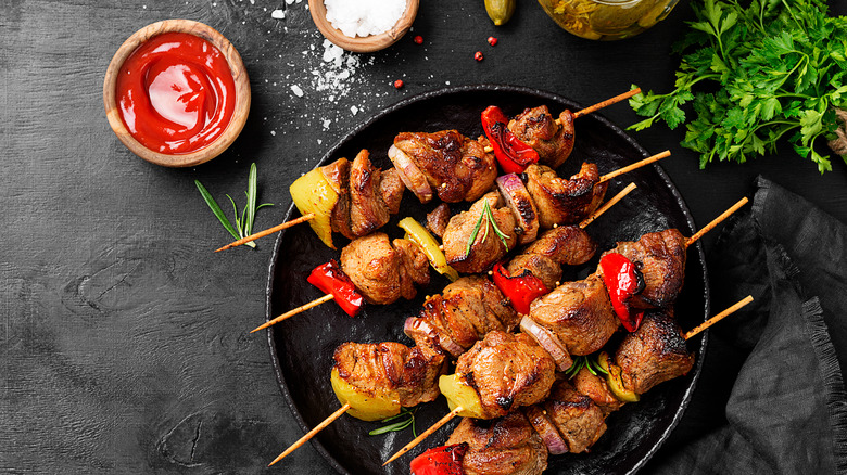 Kebabs on a black plate