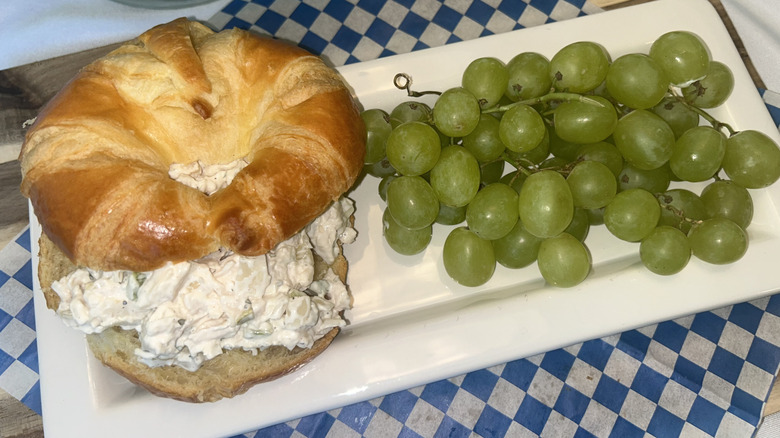 Costco chicken salad on a croissant with grapes on the side