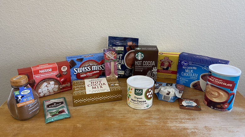 array of all hot chocolate mixes on a wooden table