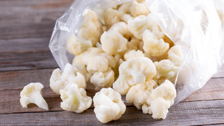 Frozen cauliflower pouring out of plastic bag