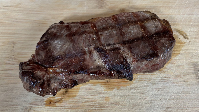 Small NY strip steak on cutting board