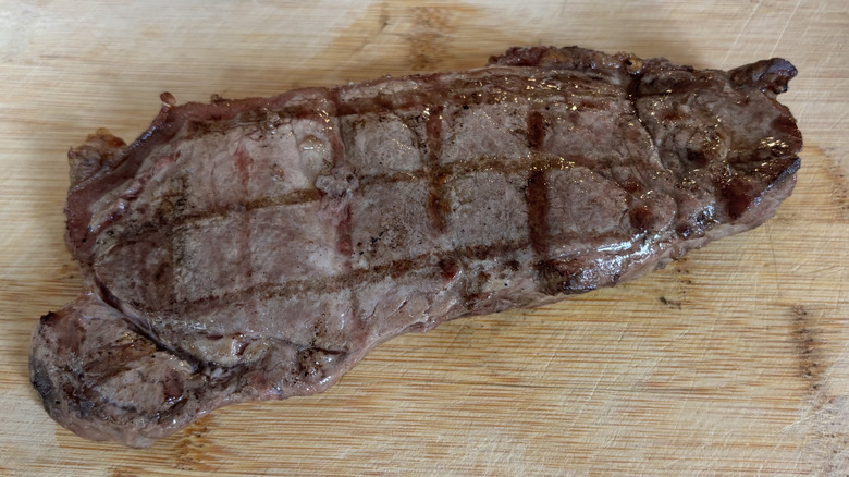 grilled NY strip steak on a cutting board