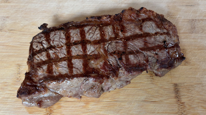 NY Strip steak with uniform width after grilling on cutting board