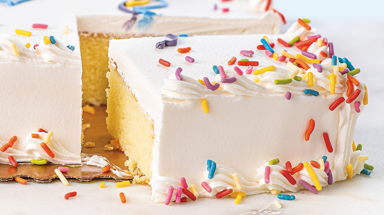 slice of frosted sheet cake with sprinkles