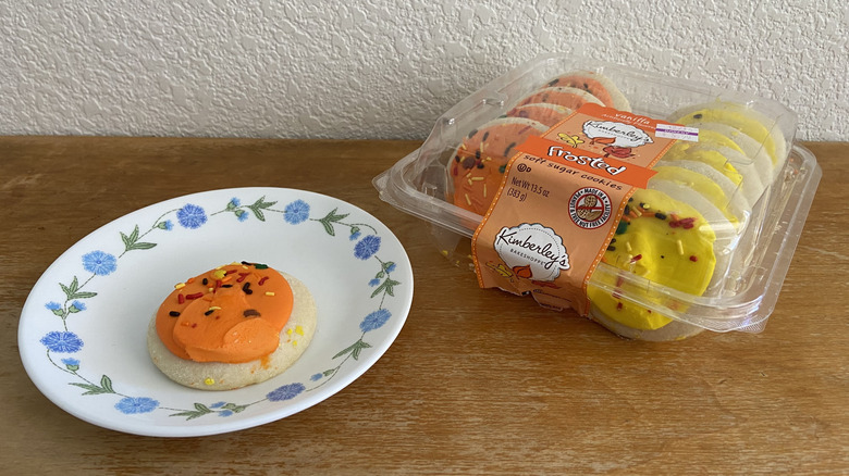 Kimberley's Bakeshoppe sugar cookie box beside single plated cookie