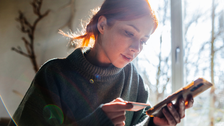 person shopping on phone with credit card
