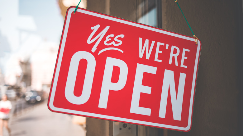 Open sign hung in store window