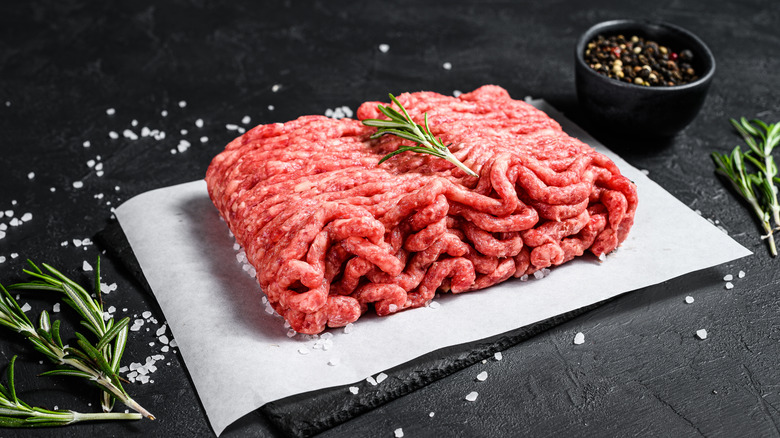 block of raw ground beef on paper