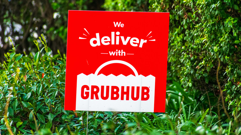Red sign with words on it about Grubhub