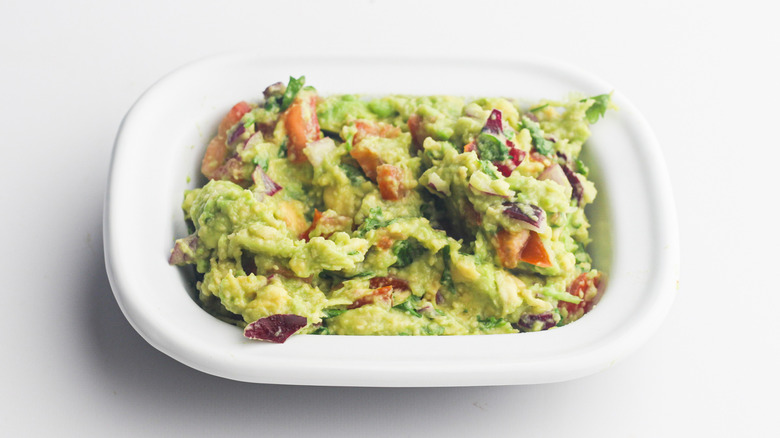 Guacamole in white serving dish.