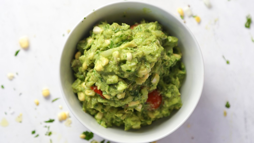 Guacamole with vine ripe tomatoes and blistered lime