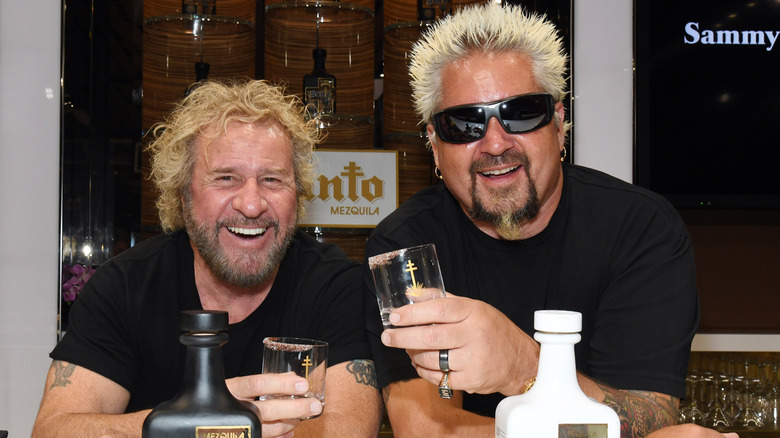 Sammy Hagar and Guy Fieri holding drinking glasses