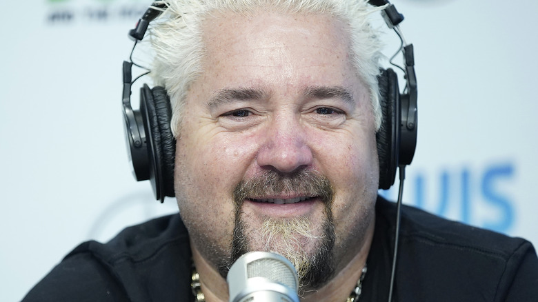 Guy Fieri smiling over radio microphone