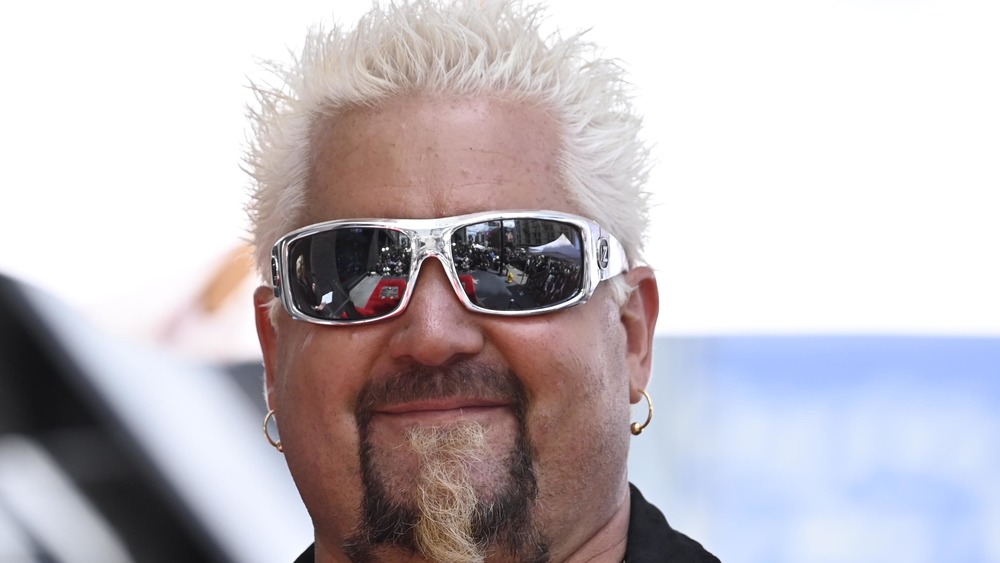 Guy Fieri smiling with earrings