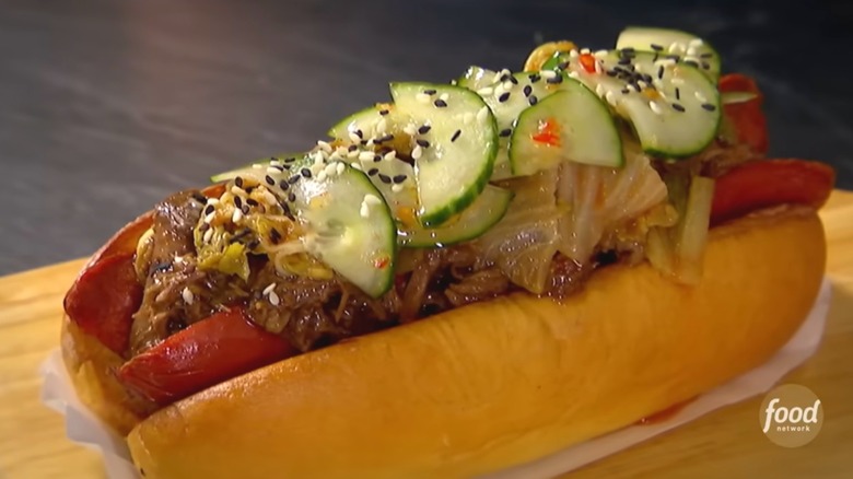 Korean dog with kimchi, cucumbers, sesame seeds