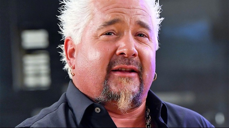 Guy Fieri with chin beard and hoop earrings 