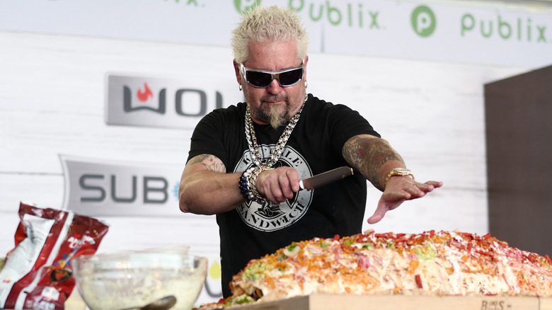 Guy Fieri cutting massive sandwich