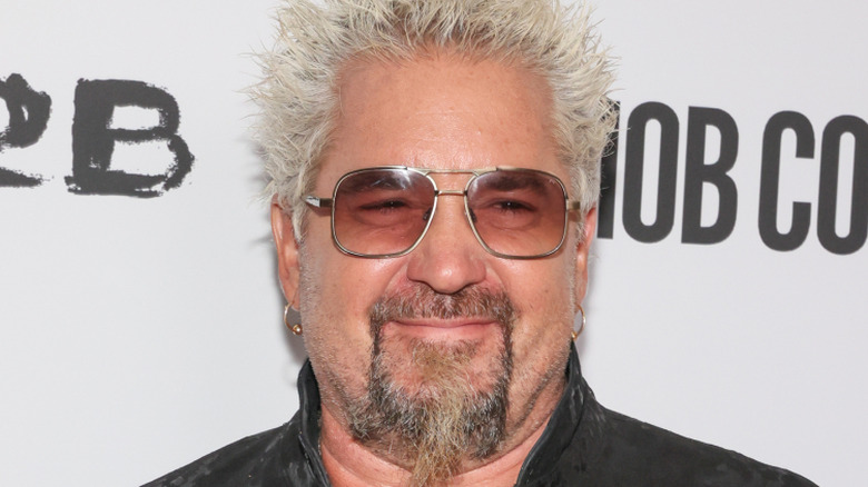 Guy Fieri wearing Aviator sunglasses at an event