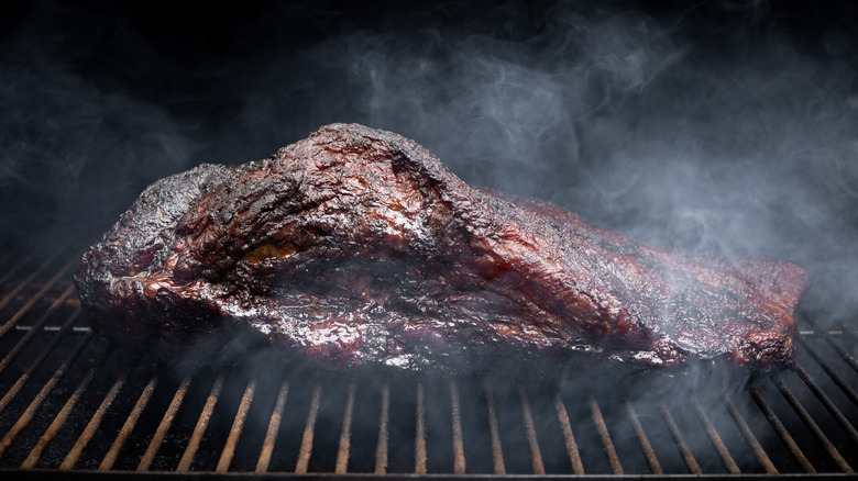 Brisket smoking on a grill