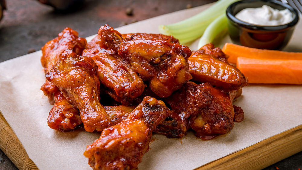 Chicken wings on a wooden platter