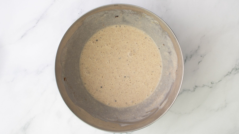 Egg wash mixture in bowl on marble surface