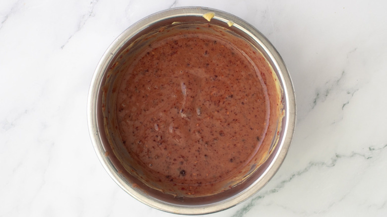 Mustard and jam mixed together in bowl